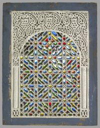 Stucco and glass window with interlaced star-and-knot ornamentation