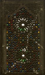 Stucco and glass window with interlaced star ornamentation