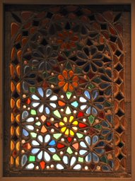 Stucco and glass window with flower and star ornamentation